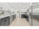 Stylish kitchen featuring stainless steel appliances, sleek counter tops, modern backsplash and contrasting cabinetry at 7 Hamilton Heath Dr, Tampa, FL 33604