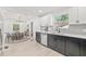 Bright kitchen and dining area features new stainless steel appliances, white cabinets and hardwood floors at 7 Hamilton Heath Dr, Tampa, FL 33604