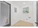 Bright laundry room featuring modern connections, a window, and a sleek exterior door at 7 Hamilton Heath Dr, Tampa, FL 33604