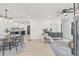 Open-concept living space with sleek ceiling fan, neutral decor, and hardwood flooring transitioning into a kitchen area at 7 Hamilton Heath Dr, Tampa, FL 33604