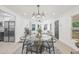 Open concept dining and living room with contemporary furnishings and finishes including a glass top table with seating for six at 7 Hamilton Heath Dr, Tampa, FL 33604