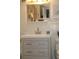 Bathroom vanity with grey cabinets, brushed nickel hardware, modern faucet, and neutral décor at 7200 Sunshine Skyway S Ln # 2E, St Petersburg, FL 33711