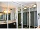 Bathroom featuring a grey vanity with a marble countertop and updated fixtures, as seen through mirrored closet doors at 7200 Sunshine Skyway S Ln # 2E, St Petersburg, FL 33711