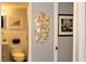 Cozy bathroom featuring a toilet, artwork, and a decorative chandelier seen from doorway at 7200 Sunshine Skyway S Ln # 2E, St Petersburg, FL 33711