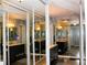 Bathroom featuring a grey vanity with a marble countertop and updated fixtures, as seen through mirrored closet doors at 7200 Sunshine Skyway S Ln # 2E, St Petersburg, FL 33711