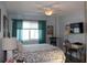 Bright bedroom with a ceiling fan, work desk, and a comfortable bed at 7200 Sunshine Skyway S Ln # 2E, St Petersburg, FL 33711