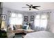 Bright bedroom boasts many windows with floral curtains, a telescope, and a comfy-looking chaise lounge at 7200 Sunshine Skyway S Ln # 2E, St Petersburg, FL 33711