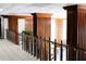 The building hallway showcases wood trim and stylish railings, adding a touch of elegance to the communal space at 7200 Sunshine Skyway S Ln # 2E, St Petersburg, FL 33711