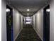 Residential hallway with a patterned carpet and doors, offering a sense of privacy at 7200 Sunshine Skyway S Ln # 2E, St Petersburg, FL 33711