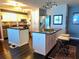 Bright kitchen boasts white cabinets, stainless appliances, and two kitchen islands at 7200 Sunshine Skyway S Ln # 2E, St Petersburg, FL 33711