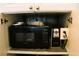 Kitchen cabinet with a microwave and Hamilton Beach Coffee Maker at 7200 Sunshine Skyway S Ln # 2E, St Petersburg, FL 33711