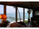 Living room featuring floor-to-ceiling windows with waterfront views, comfortable seating, and stylish decor at 7200 Sunshine Skyway S Ln # 2E, St Petersburg, FL 33711