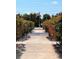 Beautiful walkway adorned with vibrant red flowers leading to an American flag at 7200 Sunshine Skyway S Ln # 2E, St Petersburg, FL 33711