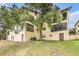 This condo building features a well-maintained lawn and mature shade trees at 7725 Forest Trl # 1, Port Richey, FL 34668