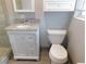 A cozy bathroom features a white vanity and a classic toilet at 888 Forest Glen Rd, Clearwater, FL 33765