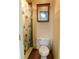 Updated bathroom with tile floors, neutral paint and a toilet and vanity cabinet at 888 Forest Glen Rd, Clearwater, FL 33765