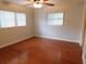 This bright bedroom has hardwood floors, white walls, and natural light from two windows at 888 Forest Glen Rd, Clearwater, FL 33765