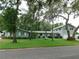Charming single-Gathering home with mature trees and lush green lawn on a quiet street at 888 Forest Glen Rd, Clearwater, FL 33765