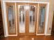 Living area features hardwood floors, wood trim, and glass paneled doors at 888 Forest Glen Rd, Clearwater, FL 33765