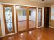 Living area features hardwood floors, wood trim, and glass paneled doors at 888 Forest Glen Rd, Clearwater, FL 33765