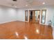 Spacious living room features hardwood floors and decorative glass doors to a second room at 888 Forest Glen Rd, Clearwater, FL 33765