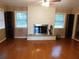 Living room featuring hardwood floors, a fireplace, and natural lighting at 888 Forest Glen Rd, Clearwater, FL 33765