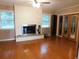 Living room featuring hardwood floors, a fireplace, and natural lighting at 888 Forest Glen Rd, Clearwater, FL 33765