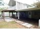 A spacious covered patio with wood flooring and a white vinyl fenced in yard at 888 Forest Glen Rd, Clearwater, FL 33765