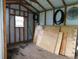 Inside of the backyard shed, featuring unfinished flooring and walls, offering potential storage at 888 Forest Glen Rd, Clearwater, FL 33765