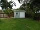 The backyard features a green shed with a sliding door for extra storage space at 888 Forest Glen Rd, Clearwater, FL 33765
