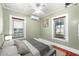 Comfortable bedroom with two windows, ceiling fan and accent wall at 931 28Th N Ave, St Petersburg, FL 33704