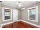 Bedroom with hardwood floors, a ceiling fan, and two windows for ample light at 931 28Th N Ave, St Petersburg, FL 33704