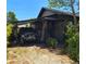 Charming home exterior featuring a sun porch and covered parking at 931 28Th N Ave, St Petersburg, FL 33704