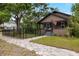 Charming bungalow with a quaint front porch, flag, walkway lighting, and manicured landscaping at 931 28Th N Ave, St Petersburg, FL 33704