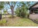 Beautiful home with a fenced yard, lush greenery, and mature trees at 931 28Th N Ave, St Petersburg, FL 33704