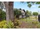 Beautiful landscaped front yard with a fenced perimeter and mature trees at 931 28Th N Ave, St Petersburg, FL 33704