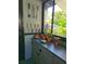 Charming gardening station with tool storage and potted plants on sun porch at 931 28Th N Ave, St Petersburg, FL 33704