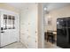 Hallway with white cabinets and a view of the work area with a vintage refrigerator at 931 28Th N Ave, St Petersburg, FL 33704