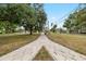 Beautiful sidewalk along a greenway with mature trees and landscaping in the neighborhood at 931 28Th N Ave, St Petersburg, FL 33704