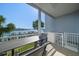 Enjoy waterfront views from this outdoor balcony featuring palm trees, a table and seating at 9939 1St E St, Treasure Island, FL 33706
