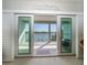 Balcony view through sliding glass doors, with a peaceful view of the water at 9939 1St E St, Treasure Island, FL 33706
