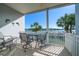 Relaxing balcony with waterfront views featuring patio seating, a table, and a refreshing coastal breeze at 9939 1St E St, Treasure Island, FL 33706