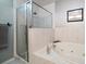 Bathroom features a large shower, jetted tub, and tile surround at 9939 1St E St, Treasure Island, FL 33706