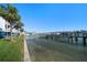 Beautiful waterfront property with private boat dock and clear ocean views, palm trees, and blue skies at 9939 1St E St, Treasure Island, FL 33706