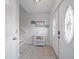 Bright entryway with a decorative glass front door and light wood-look flooring, featuring white walls at 9939 1St E St, Treasure Island, FL 33706