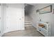 Bright entryway with a storage console and light wood-look flooring; stairs lead up to the second level at 9939 1St E St, Treasure Island, FL 33706