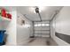 Clean one car garage features automatic door, storage and shelving at 9939 1St E St, Treasure Island, FL 33706