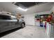 Well-lit garage with automatic door, storage and vehicle at 9939 1St E St, Treasure Island, FL 33706