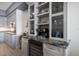 Modern kitchen with a wine fridge and storage, with open display shelving and granite countertops at 9939 1St E St, Treasure Island, FL 33706