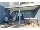 Inviting covered patio with a hot tub, spiral staircase, seating area, and access to the waterfront at 9939 1St E St, Treasure Island, FL 33706
